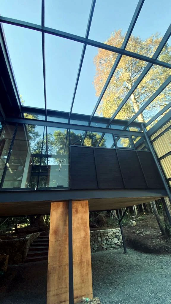 Estructura metálica elevada con cerramientos de vidrio durante ejecución